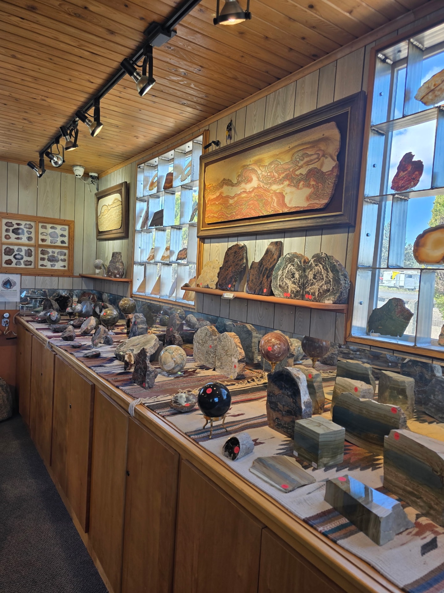 Inside Madani Rock World showroom with agate panels, spheres, and petrified wood displays