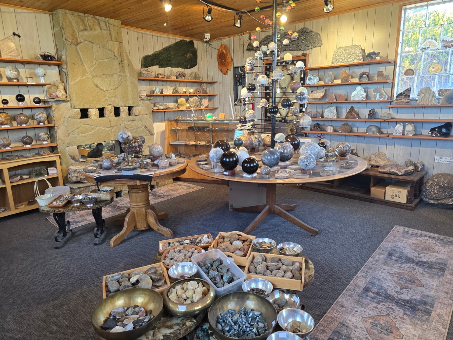 Sphere tables and stone fireplace inside Madani Rock World