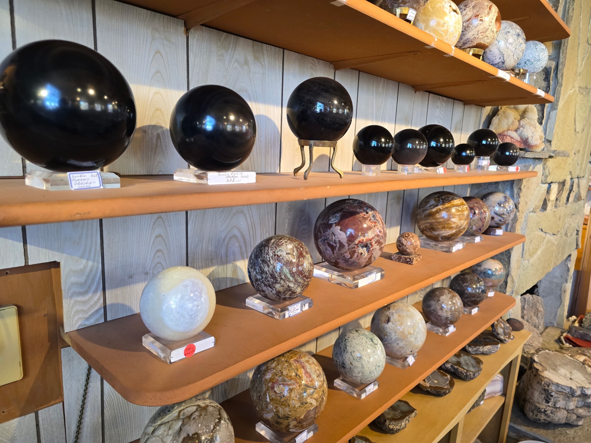 Shelves of obsidian and jasper spheres of varying sizes